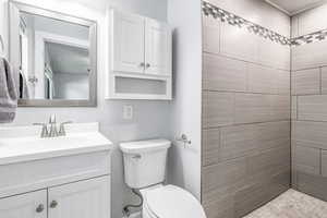 Bathroom with vanity and tiled shower