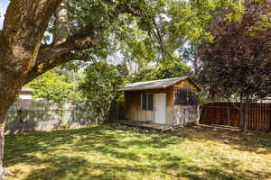 View of shed featuring a fenced backyard