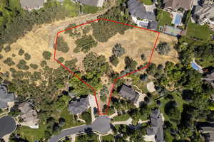 Aerial perspective of suburban area with property boundaries highlighted