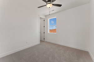 Unfurnished room featuring light carpet and ceiling fan