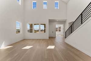 Foyer entrance featuring light wood-style floors and stairway
