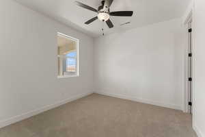 Empty room with light carpet and ceiling fan