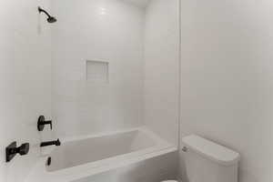 Full bath featuring toilet and shower / washtub combination