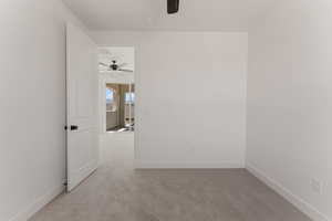 Spare room with carpet floors and a ceiling fan