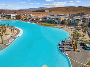 Aerial view of residential area with a mountain backdrop and a pool