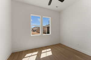 Empty room featuring wood finished floors and ceiling fan