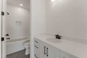 Bathroom with vanity, recessed lighting, tile patterned floors, and  shower combination