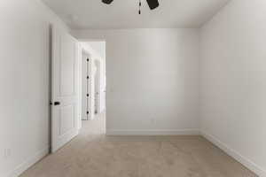 Unfurnished room with light carpet and a ceiling fan