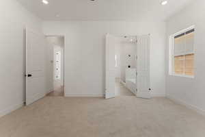 Unfurnished bedroom featuring recessed lighting and light carpet