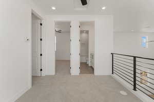 Corridor with light carpet, recessed lighting, and an upstairs landing