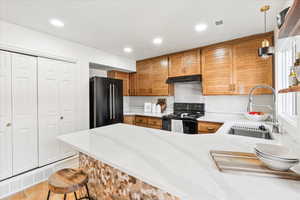 Kitchen with custom milled cabinets, spice rack and silestone counters.