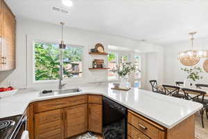 Kitchen with custom milled cabinets, spice rack and silestone counters.