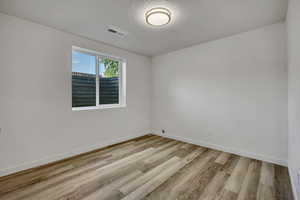 Spare room with a textured ceiling and wood finished floors