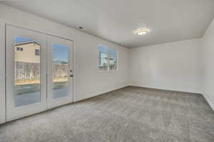Carpeted spare room with baseboards