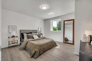 Bedroom featuring wood finished floors and baseboards