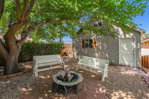 Fenced backyard featuring a patio area and an outdoor fire pit