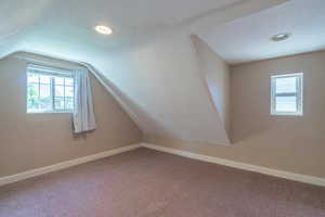 Bonus room featuring plenty of natural light, vaulted ceiling, carpet floors, and recessed lighting