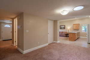 Living room with light carpet and a textured ceiling