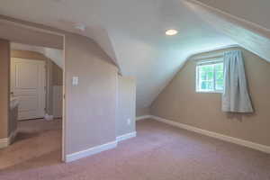 Bonus room featuring carpet, vaulted ceiling, and recessed lighting