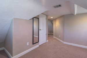 Additional living space with carpet floors, a textured ceiling, and recessed lighting