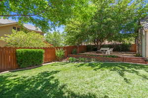 Fenced backyard with a patio area