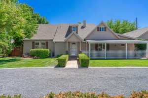 View of front of property featuring stucco siding, roof with shingles, and a chimney