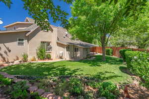 Back of house featuring stucco siding and roof with shingles
