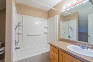 Bathroom featuring bathtub / shower combination and vanity