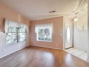 Foyer featuring wood finished floors and baseboards