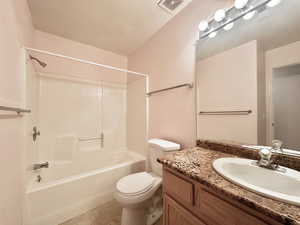 Full bathroom featuring vanity, washtub / shower combination, and tile patterned flooring