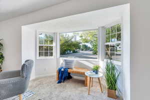 Entryway with carpet flooring and baseboards