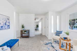 Living area featuring plenty of natural light and carpet