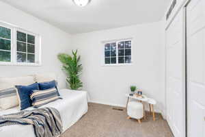 Carpeted bedroom with a textured ceiling and a closet