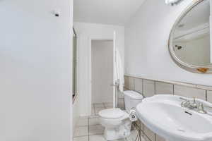 Full bath featuring tile patterned floors and combined bath / shower with glass door