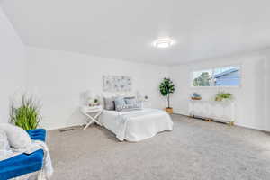 Carpeted bedroom with baseboards