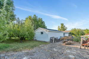 Rear view of property with an outbuilding
