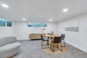 Dining space with carpet floors and recessed lighting