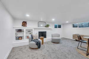 Sitting room with carpet, a fireplace, and recessed lighting