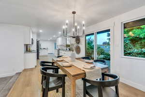 Dining room with a chandelier, light wood-style flooring, and recessed lighting