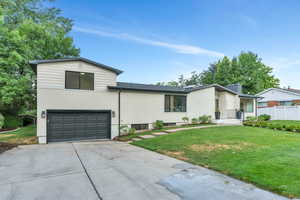 View of front of house with driveway and a garage