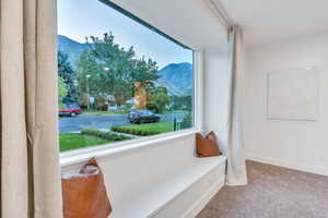 Living area with carpet and a mountain view