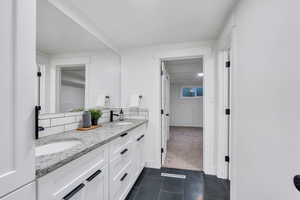 Bathroom featuring double vanity and tile patterned flooring