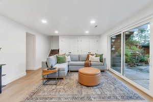 Living area featuring recessed lighting, stairs, and light wood finished floors