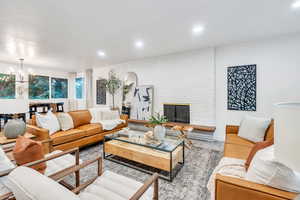 Living area featuring recessed lighting, a chandelier, and a fireplace