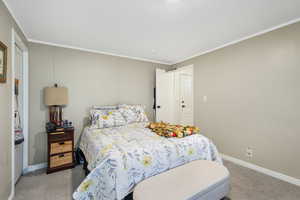 Bedroom with carpet floors and ornamental molding