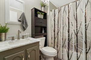 Bathroom with vanity and curtained shower