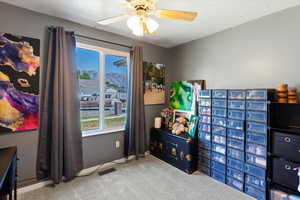 Recreation room with carpet flooring and a ceiling fan