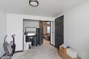 Spare room featuring a textured ceiling and baseboards