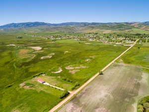 Aerial view of property's location featuring a mountainous background and rural landscape