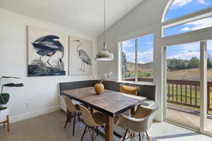Dining room featuring lofted ceiling and wood finished floors